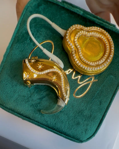 Afterglow cochlear jewellery on green velvet case