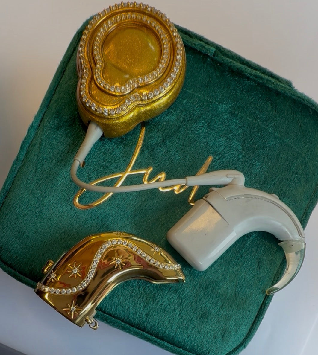 Afterglow cochlear jewellery shown beside cochlear processor
