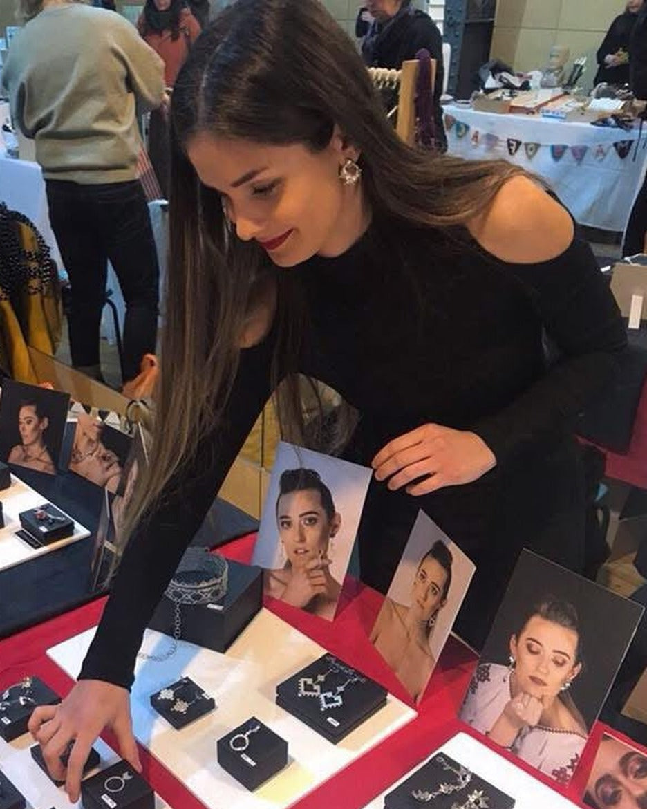 Daniela at an early jewellery stall, showcasing her handmade pieces