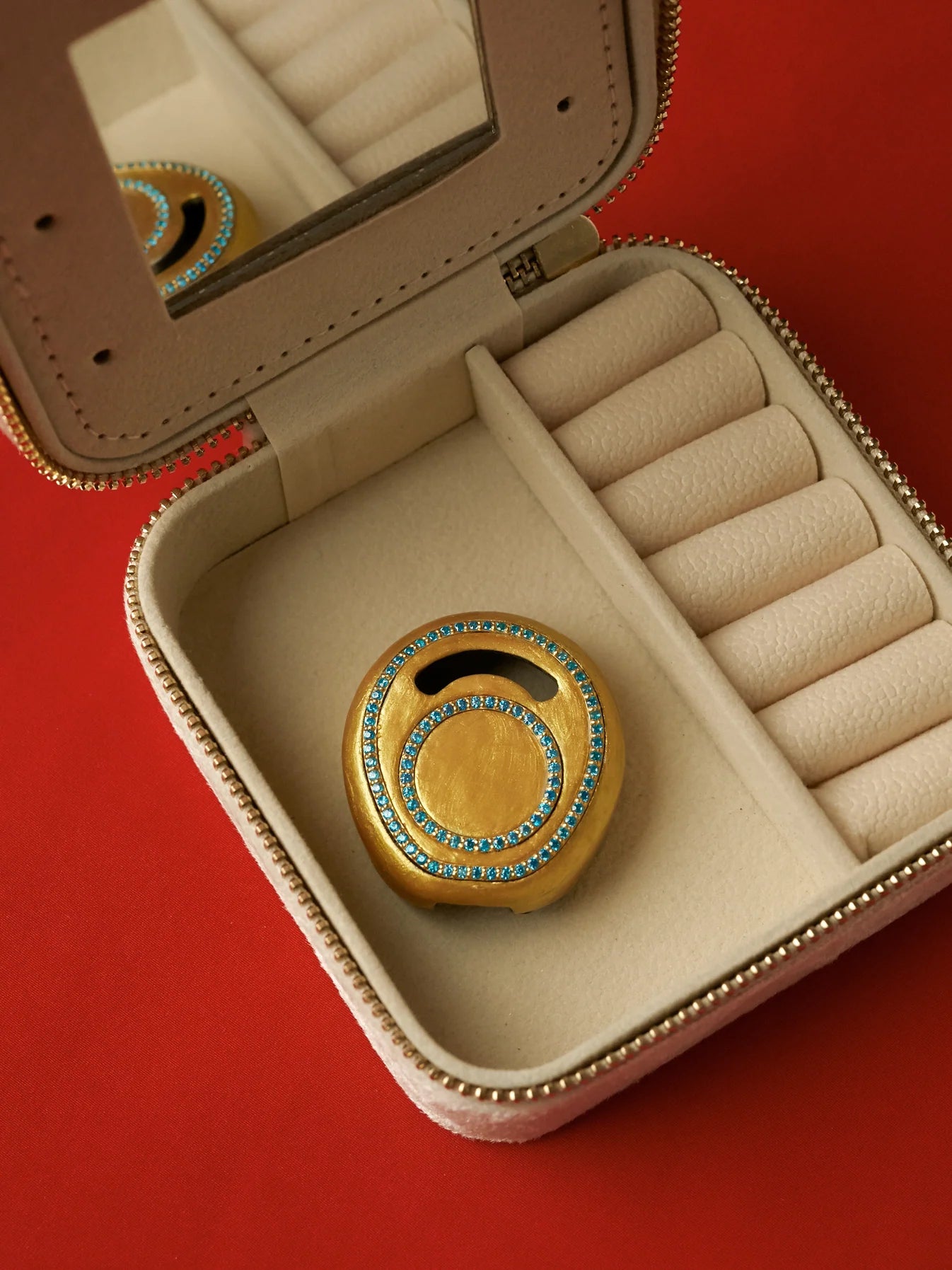 Finished gold Enchanted Kanso cover with turquoise gemstones inside a luxury jewellery box