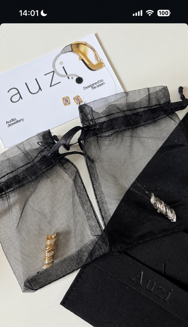 Lola Wignall's Auzi HEARLOOM jewellery in black organza pouches beside Auzi packaging
