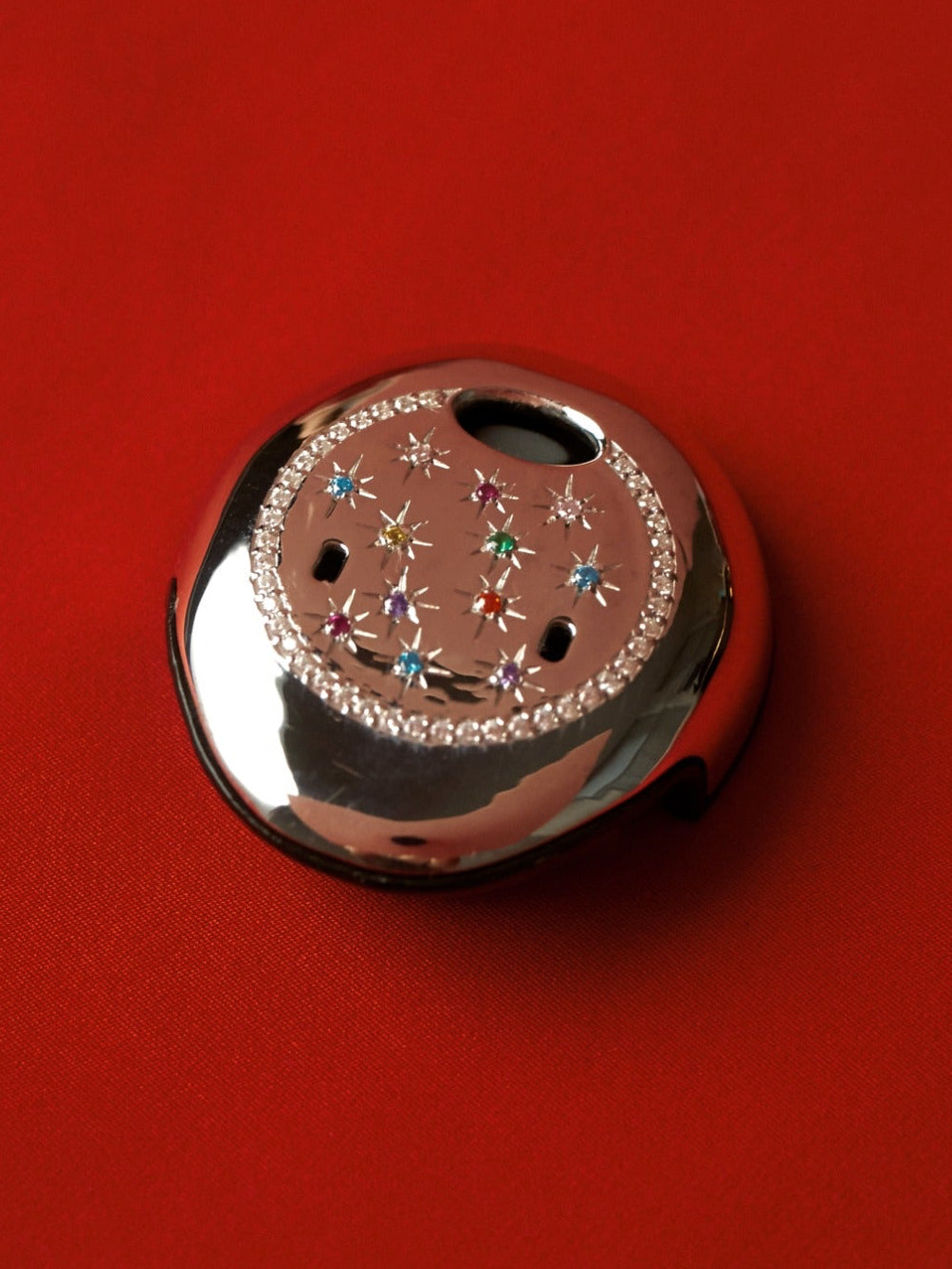 Osia Celeste silver gemstone jewellery cover for Cochlear Osia 2, photographed on red