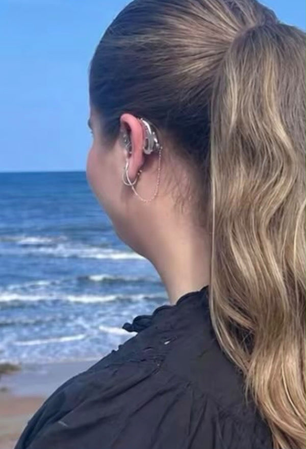Rose wearing custom silver Auzi hearing aid covers and HEARLOOM jewellery