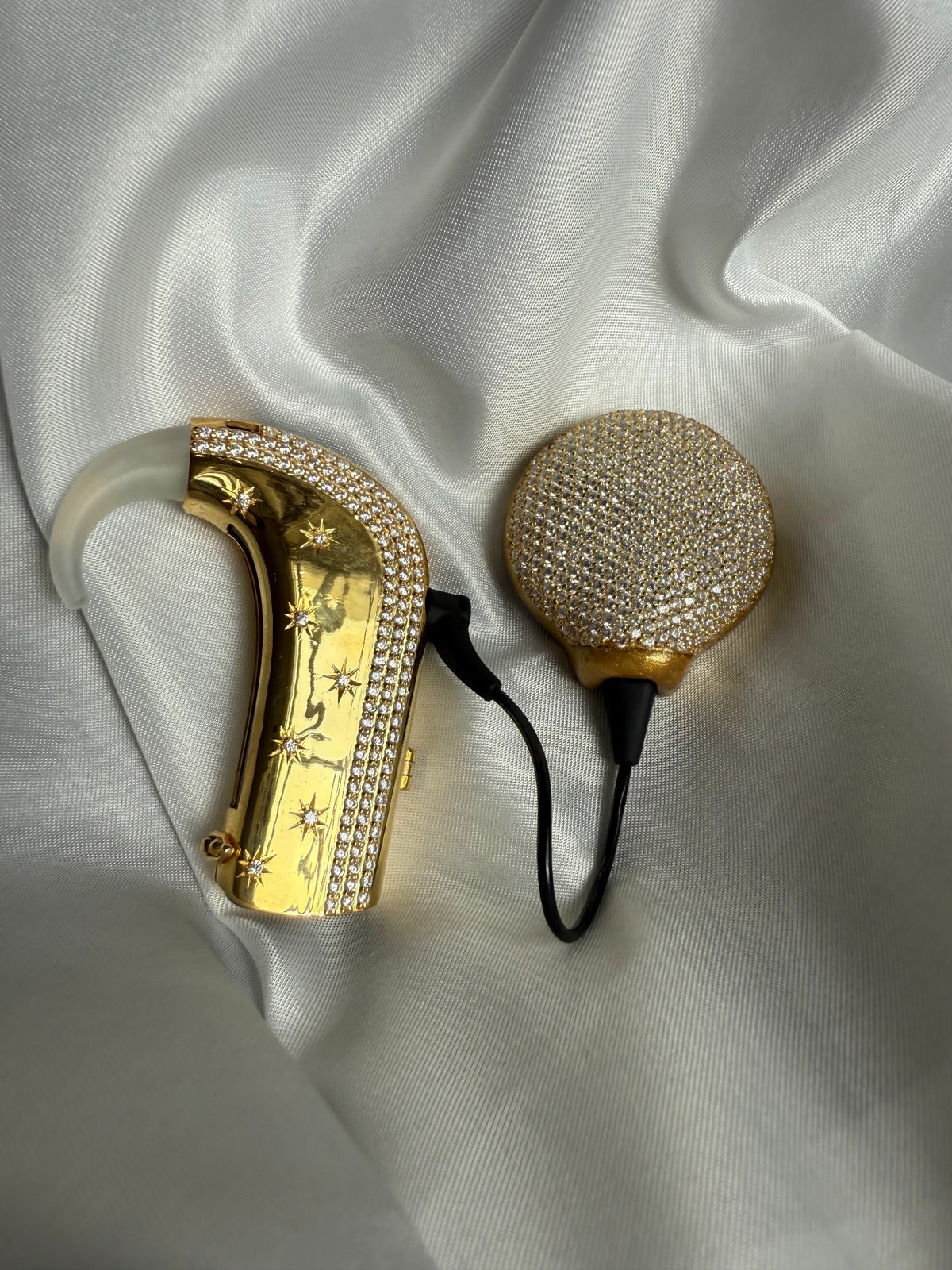 Shine Bright cochlear processor and coil jewellery on satin